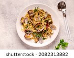 Seafood pasta with clams Spaghetti alle Vongole on a light background. Top view