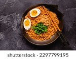 Small photo of Korean style instant noodle, Shin Ramyeon with peanut and egg, top view.