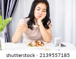 Small photo of Asian woman having problem with anorexia ,bored with food, and lost appetite