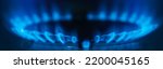 Small photo of Close-up natural gas flame. Gas flame on dark background. Blue flames from gas stove burner