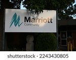 Small photo of McKinnon, Victoria, Australia - December 29 2022: Marriott Community sign, outside the disability support services organisation's Wheatley Rd hub, with a distinctive sculpture in the background