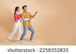 Small photo of Handsome young asian man with broken arm in soft splint and woman with neck splint and bandage pointing at an empty blank copy space for advertising, and promotion. - full body legnth