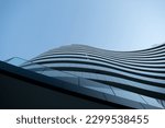 A modern building with interesting architectural curves in Novi Sad Serbia. Picture taken on a bright blue sky day. Shadows falling perfectly on the building