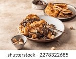 Crepes with chocolate and hazelnuts on beige background. Thin pancakes as delisious breakfast or dessert concept, Pancake day, Maslenitsa. Horisontal