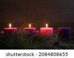 Advent wreath with three candles lit, with pillar candles and copy space