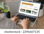 Small photo of booking online concept, person using laptop computer planning travel search hotel booking.