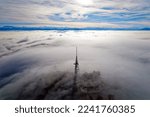 Aerial view from local mountain Uetliberg on a foggy winter day with Swiss Alps and sea of fog at Christmas Day. Photo taken December 25th, 2022, Uetliberg, Canton Zürich, Switzerland.