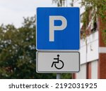 Close-up shot of a handicapped parking sign attached on a  metal pole 