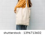 Woman is holding tote bag...