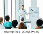 Small photo of Portrait of a young doctor teaching on a seminar in a board room or during an educational class at convention center