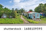 Three colorful typical homes in Antigua Barbuda Lesser Antilles, West Indies, Caribbean.


