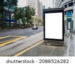 Vertical blank billboard ad mock up at a bus stop in the Central Business District of Singapore.