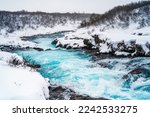 Midfoss Waterfall. The 'Iceland’s Bluest Waterfall.' Blue water flows over stones. Winter Iceland. Visit Iceland. Hiking to bruarfoss waterfall