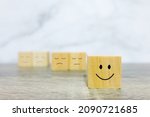 Small photo of Woodblock cubes with emotions. single block is happier than couple block. Self happiness concept.