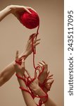 Small photo of Friendship. Hand holds ball of threads and hands nearby unravel this tangle, intertwining and uniting against sandy color studio background. Concept of human touch, beauty and care, spa procedures.
