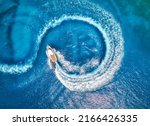 Small photo of Aerial view of the speed boat in clear blue water at sunset in summer. Top view from drone of fast floating yacht in mediterranean sea. Travel in Oludeniz, Turkey. Tropical landscape with motorboat