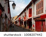Small photo of Perspective view of the Street of Happiness (Rua da Felicidade) flanked by traditional Chinese houses with conspicuous red doors and windows in Macau, China This is a bygone Red Light district
