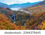 Small photo of A breathtaking view of Kegon Waterfalls 華厳滝, which tumbles from Lake Chuzenji into a gorge, with brilliant fall colors on rocky cliffs on a beautiful autumn day, in Nikko National Park, Tochigi, Japan