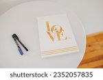 Small photo of Guestbook at a wedding with two pens