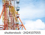 Small photo of Double A stand unilateral support, central shaft, slewing bearing, wire rope, outer rim and sightseeing cabin multiple passengers carrying components modern colorful Ferris Wheel, Nha Trang. Vietnam
