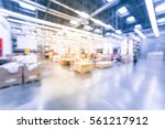 Blurred customers shopping in large furniture warehouse with forklift, cart. Row aisle, bins from floor to ceiling. Industrial storehouse interior. Inventory, wholesale, logistic, export. Vintage tone