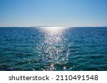 Sparkling sea in the sunlight with Croatian islands in the background, blue sky
