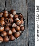 Small photo of Hazelnuts in openwork plate on teriann background rustic