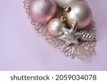 Small photo of Christmas decorations in pastel colors. Christmas background. delicate colors. pink, purple, lilac, white glamour color, light tones. yappy new year. bulb, toys