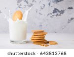 Shortbread kamut cookie falling into a glass of milk