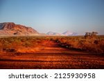 Small photo of One of the most beautiful red dirt-roads in the Karijini National Park in Western Australia at sunset.