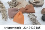 Small photo of Handmade Ribbon brooch with a sweet combination of yellow and brown. Beautifully worn on your shirt or headscarf, brooches can be combined with soft colors like beige, white or light blue.