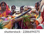 Small photo of Ranchi, Jharkhand- November 11,2021: Hindu devotee offering prayers to sun god standing in water according to hindu rituals during Chhath Puja Festival. Chath Puja rituals