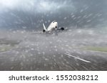 Airliner taking off from the runway at the airport during bad weather, low visibility, snow. Concept of delayed or late flights