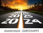 Small photo of Text 2024-2026 written on the road in the middle of asphalt road with at sunset. Concept of planning, goal, challenge, new year resolution,noise, selective focus