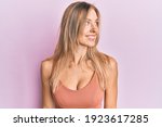 Beautiful caucasian woman wearing casual clothes looking to side, relax profile pose with natural face and confident smile. 