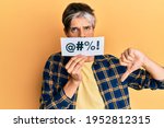 Small photo of Young hispanic man covering mouth with insult message paper with angry face, negative sign showing dislike with thumbs down, rejection concept