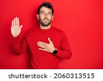 Small photo of Handsome man with beard wearing casual red sweater swearing with hand on chest and open palm, making a loyalty promise oath