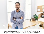 Small photo of Young arab man smiling confident standing with arms crossed gesture at office