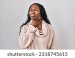 Small photo of African woman standing over white background touching painful neck, sore throat for flu, clod and infection