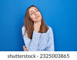 Young woman standing over blue background touching painful neck, sore throat for flu, clod and infection 