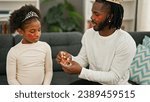 Small photo of African american father and daughter wearing king crown and baggy eyes pad at home