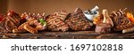 Small photo of A selection of grilled gourmet meats on a rustic timber board.