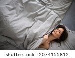 Small photo of Pretty, young woman in her bed, fast asleep. Importance of sleep concept