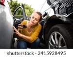 Small photo of Pretty, young woman checking the state of a car for insurance purposes, prior to start driving it after renting it from a car rental. Automotive damage liability concept.