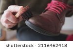 Small photo of Caucasian Male Using Soft Horsehair Brush to Apply Brown Shoe Shine Wax to Protect and Impregnate Leather Boots Shoes Wide