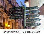 Small photo of Signpost in the City Centre with directions to tourist attractions.In the evening hours.Malaga, Spain, Andalusia.