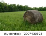 A Farming Field With Bales Of...