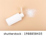 Hypoallergenic baby powder on light beige background