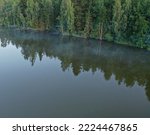 Morning fog shrouded the forest river. Fairy mist. Fog over the river. Fog over the lake. Ancient lake. Ancient lake. The forest is right next to the water. Dark green deep lake in the forest.