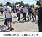 Small photo of Tel Aviv, Israel - August 10, 2022: Some men and women gather around economist Avraham Avi Simhon (Simchon). Boaz Bismuth tent in the background Likud party primary election at Menora Mivtachim Arena.